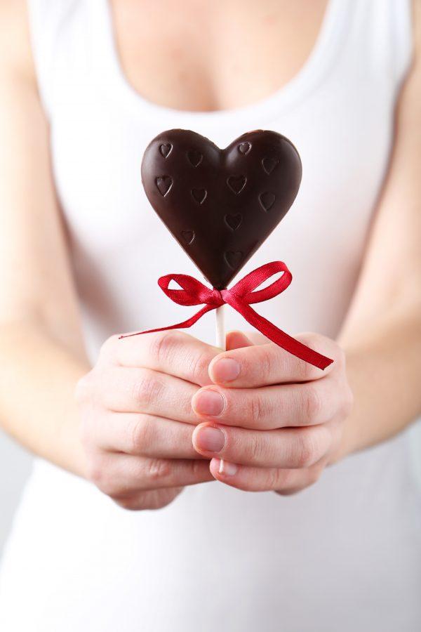 Woman holding a chocolate heart. (5 second Studio/Shutterstock)