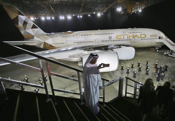 FILE—In this Dec. 18, 2014, file photo, an Emirati man takes a selfie in front of a new Etihad Airways A380 in Abu Dhabi, United Arab Emirates. (Kamran Jebreili/AP)