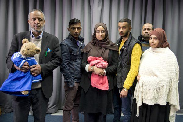 The families of Shamima Begum and Amira Abase pose for a portrait after being interviewed by the media at New Scotland Yard, London, on Feb. 22, 2015. (Laura Lean/PA Wire/Getty Images)