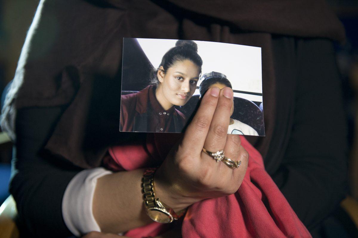 Renu, the eldest sister of Shamima Begum, holds her sister's photo while being interviewed by the media at New Scotland Yard in London, on Feb. 22, 2015. (Laura Lean/PA Wire/Getty Images)