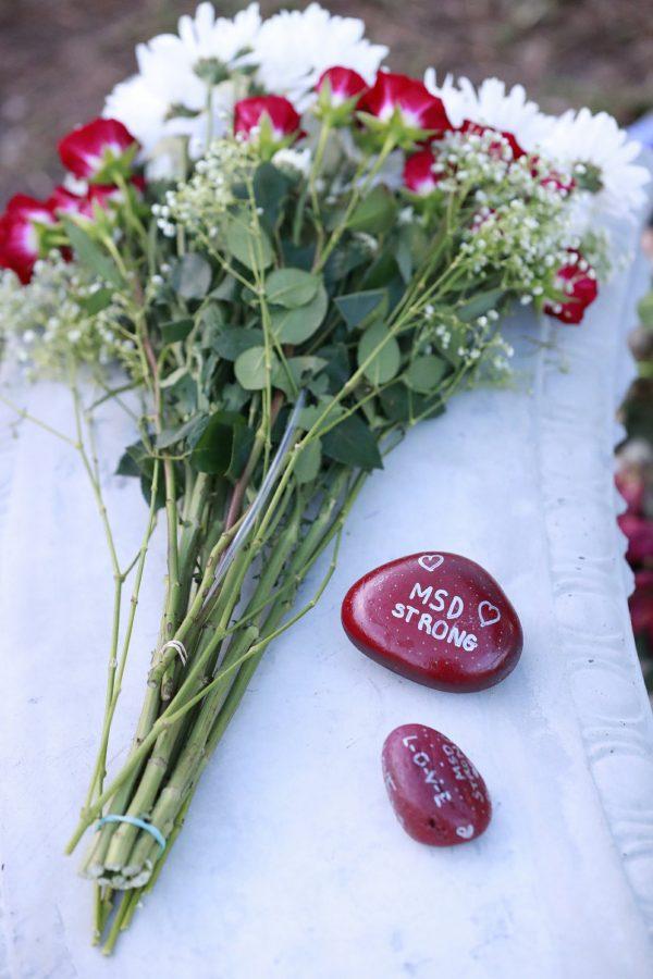 Flowers and stones are at a memorial outside Marjory Stoneman Douglas High School during the anniversary of the school shooting, in Parkland, Fla., on Feb. 14, 2019. (Wilfredo Lee/AP Photo)