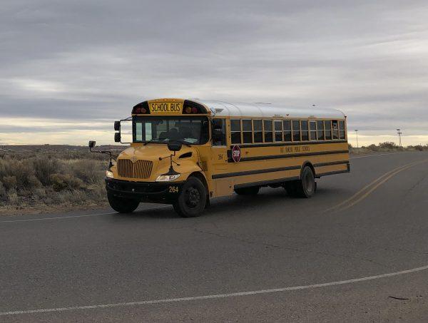 A school bus evacuates students from Sue V. Cleveland High School after a shot was fired on the campus in Rio Rancho, New Mexico, on Feb. 14, 2019. (Russell Contreras/AP Photo)