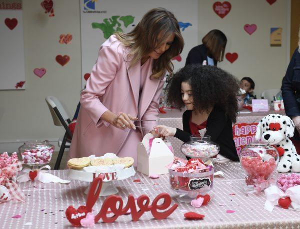 First Lady Melania Trump fills a box with candy with the help of Amber, 9, of San Jose, Calif., during her visit to the National Institutes of Health to see children at the Children's Inn and to celebrate Valentine's Day, in Bethesda, Md., on Feb. 14, 2019. (Susan Walsh/AP)