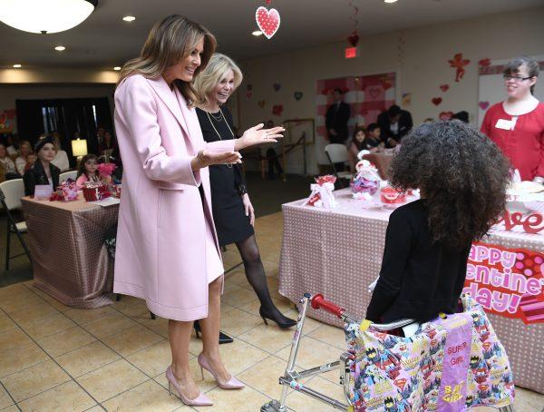 First Lady Melania Trump, left, reacts as she sees Amber, 9, of San Jose, Calif., during her visit to the National Institutes of Health to see children at the Children's Inn and to celebrate Valentine's Day, in Bethesda, Md., on Feb. 14, 2019. (AP Photo/Susan Walsh)