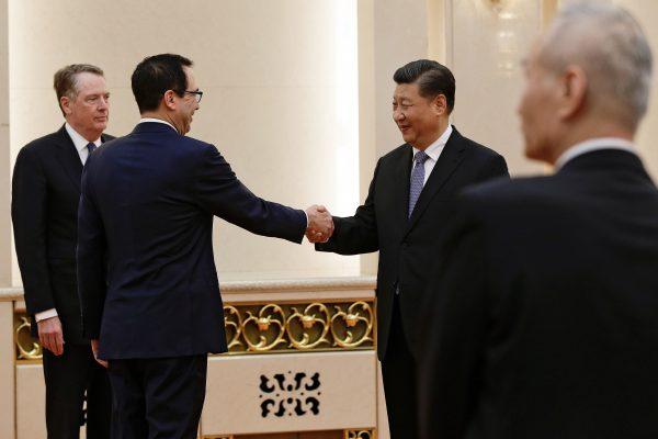 U.S. Treasury Secretary Steven Mnuchin shakes hands with Chinese leader Xi Jinping as U.S. Trade Representative Robert Lighthizer, left, and Chinese Vice Premier Liu He, right, look on before proceeding to their meeting at the Great Hall of the People in Beijing on Feb. 15, 2019. (Andy Wong/Pool via Reuters)