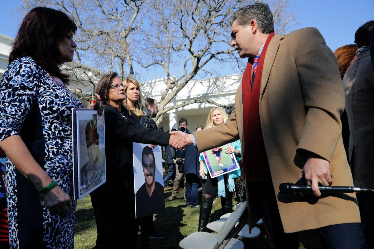 CNN correspondent Jim Acosta speaks to relatives of victims killed by illegal aliens after President Donald Trump spoke on border security during a Rose Garden event at the White House, on Feb. 15, 2019. (Chip Somodevilla/Getty Images)
