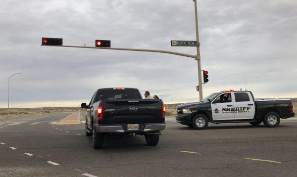 A Sandoval County sheriff's deputy stops a motorist near Sue Cleveland High School in Rio Rancho, New Mexico, on Feb. 14, 2019. (AP Photo/Russell Contreras)