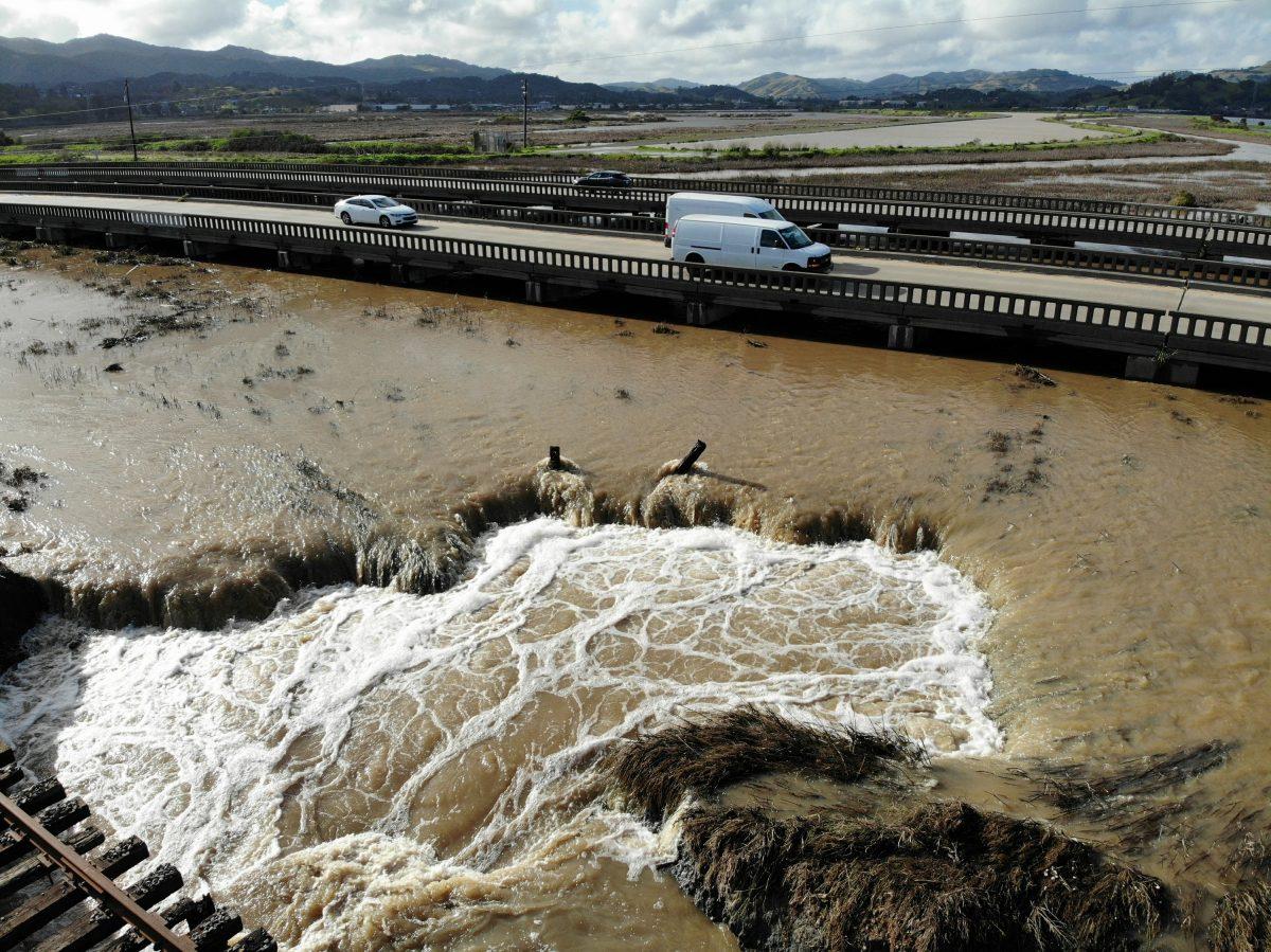 Water from recent heavy rain storms breeches a levee in Novato, Calif., on Feb. 14, 2019. (AP Photo/Terry Chea)