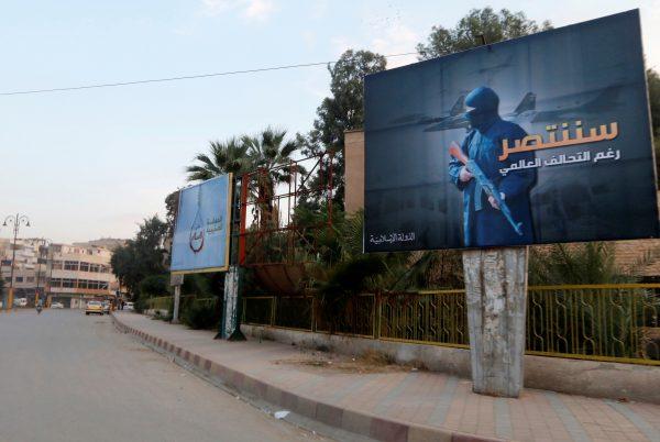 ISIS terrorist group billboards are seen along a street in Raqqa, eastern Syria, which is controlled by the terrorists, on Oct. 29, 2014. The billboard (R) reads: "We will win despite the global coalition." (Nour Fourat/Reuters)