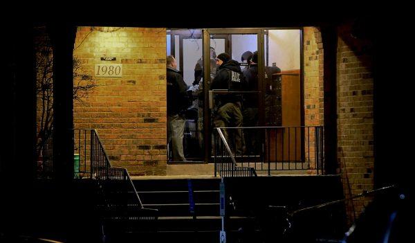 Investigators enter an apartment building in Aurora, Ill., where a man who police say fatally shot several people and injured police officers at a manufacturing plant in Aurora is believed to have lived, on Feb. 15, 2019. (Matt Marton/AP Photo)
