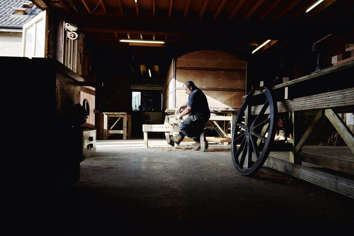 The trade of coachbuilding and wagon making is a critically endangered heritage craft. Greg Rowland offers cartwheel-making classes, as an Airbnb Experience in order to raise awareness of his trade. (Rankin Studios)