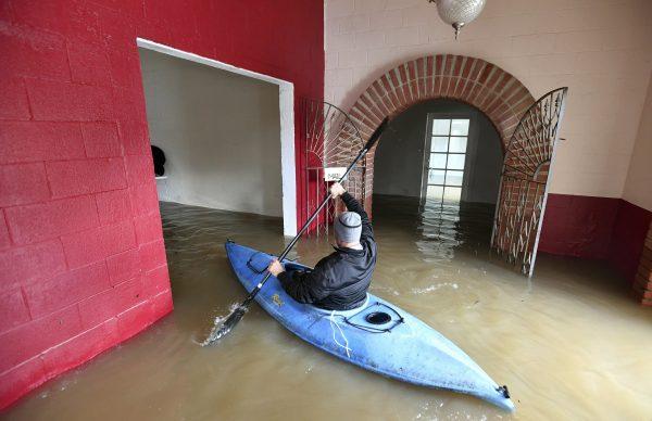 Jay Michael Tucker kayaks through the flooded Surrey Resort as the Russian River flows through it in Guerneville, Calif., on Feb. 15, 2019. (Josh Edelson/AP)