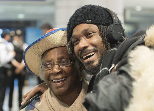 A woman and man hug at Trudeau airport in Montreal on Feb. 16, 2019. More than 100 Quebec tourists who had been trapped in Haiti amid violent street protests were flown back to Montreal. (THE CANADIAN PRESS/Graham Hughes)