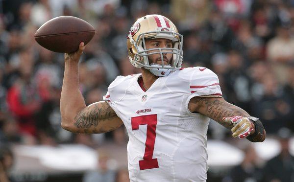 File photo showing now former San Francisco 49ers quarterback Colin Kaepernick (7) passing against the Oakland Raiders during the second quarter of an NFL football game in Oakland, Calif., Sunday, Dec. 7, 2014. (Marcio Jose Sanchez/AP Photo)