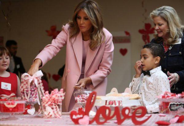 First Lady Melania Trump fills Valentines Day boxes with candy with 10-year-old immune deficiency patient Avery (L) from Festus, Mo., and 9-year-old Josue (R) of Puerto Rico as she visits with children during a Valentineís Day visit with young patients at the Children’s Inn at the National Institutes of Health (NIH) in Bethesda, Md., on Feb 14, 2019. (Jonathan Ernst/Reuters)