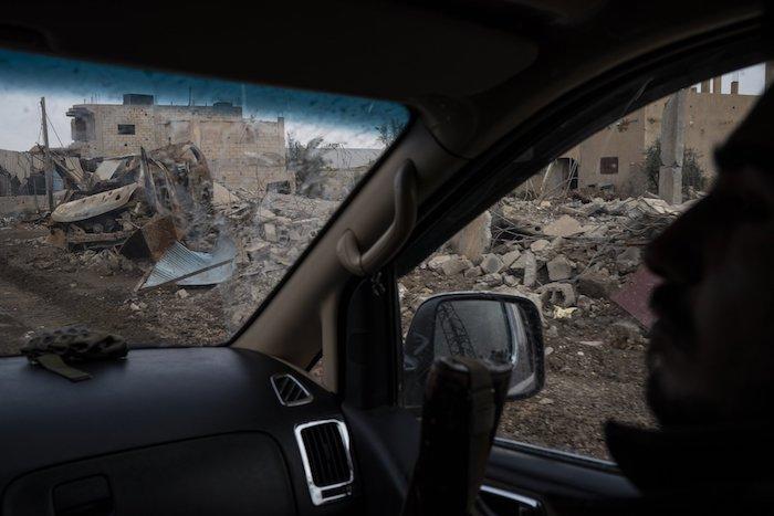  A U.S.-backed Syrian Democratic Forces (SDF) fighter rides past destroyed homes and vehicles in a village recently retaken from ISIS terrorists in Susah, Syria, on Feb. 16, 2019. (Felipe Dana/AP Photo)