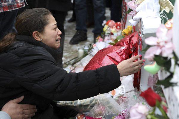 One of victim Vicente Juarez's daughter Diana Juarez cries at a makeshift memoria in Aurora, Ill., on Feb. 17, 2019. (Nam Y. Huh/AP)