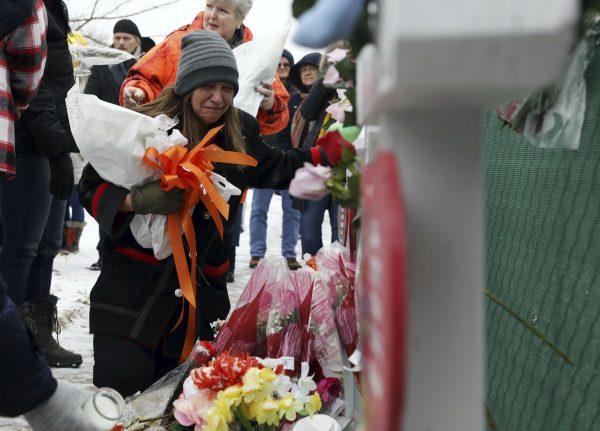People pray at a makeshift memorial in Aurora, Ill., on Feb. 17, 2019. (Nam Y. Huh/AP)