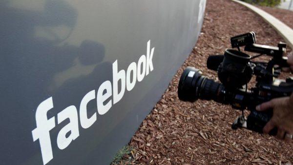 A television photographer shoots the sign outside of Facebook headquarters in Menlo Park, Calif. A parliamentary committee report published on Feb. 17, 2019, has recommended that the UK government increase oversight of social media platforms like Facebook to better control harmful or illegal content. (Paul Sakuma/AP Photo)