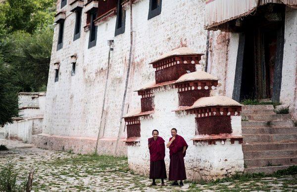 Two monks standing next to the Buddhist Sera monastery in the regional capital Lhasa, Tibet, on September 11, 2016. (JOHANNES EISELE/AFP/Getty Images)