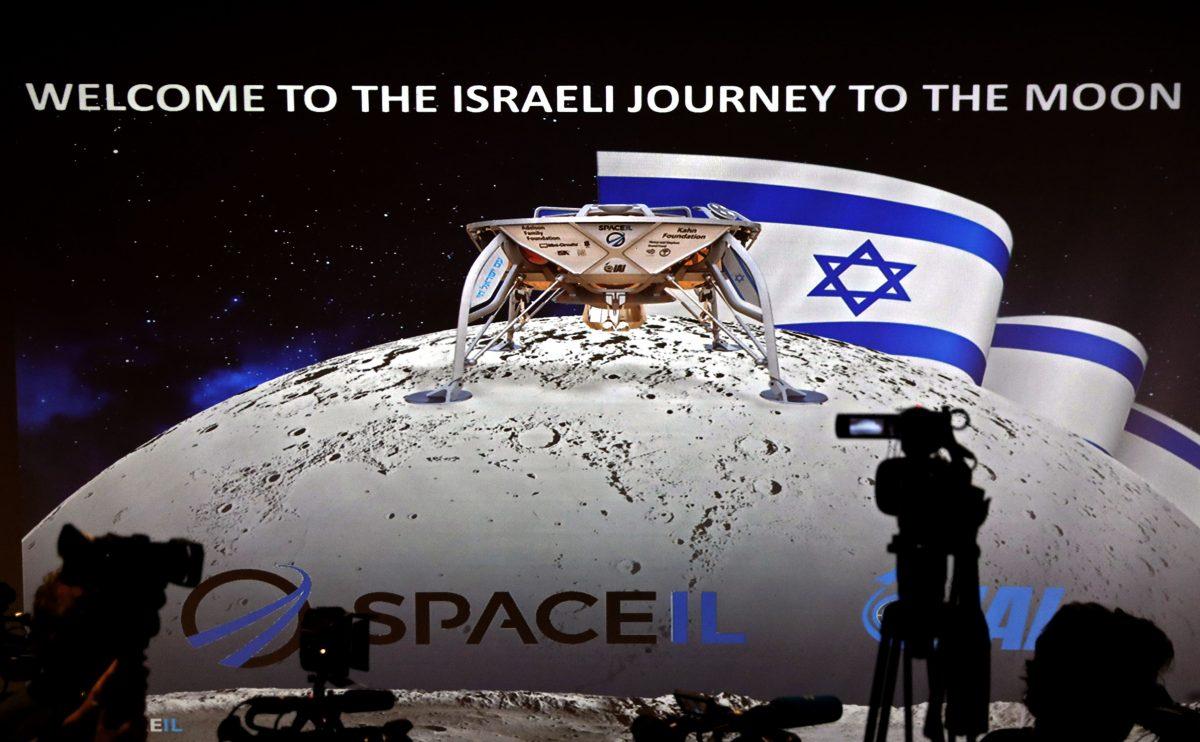 Journalists prepare to attend a press conference by Israeli Aerospace Industries space division to announce the launch of a spacecraft to the moon at the end of 2018 in Yehud, Eastern Tel Aviv, on July 10, 2018. (Thomas Coex/AFP)
