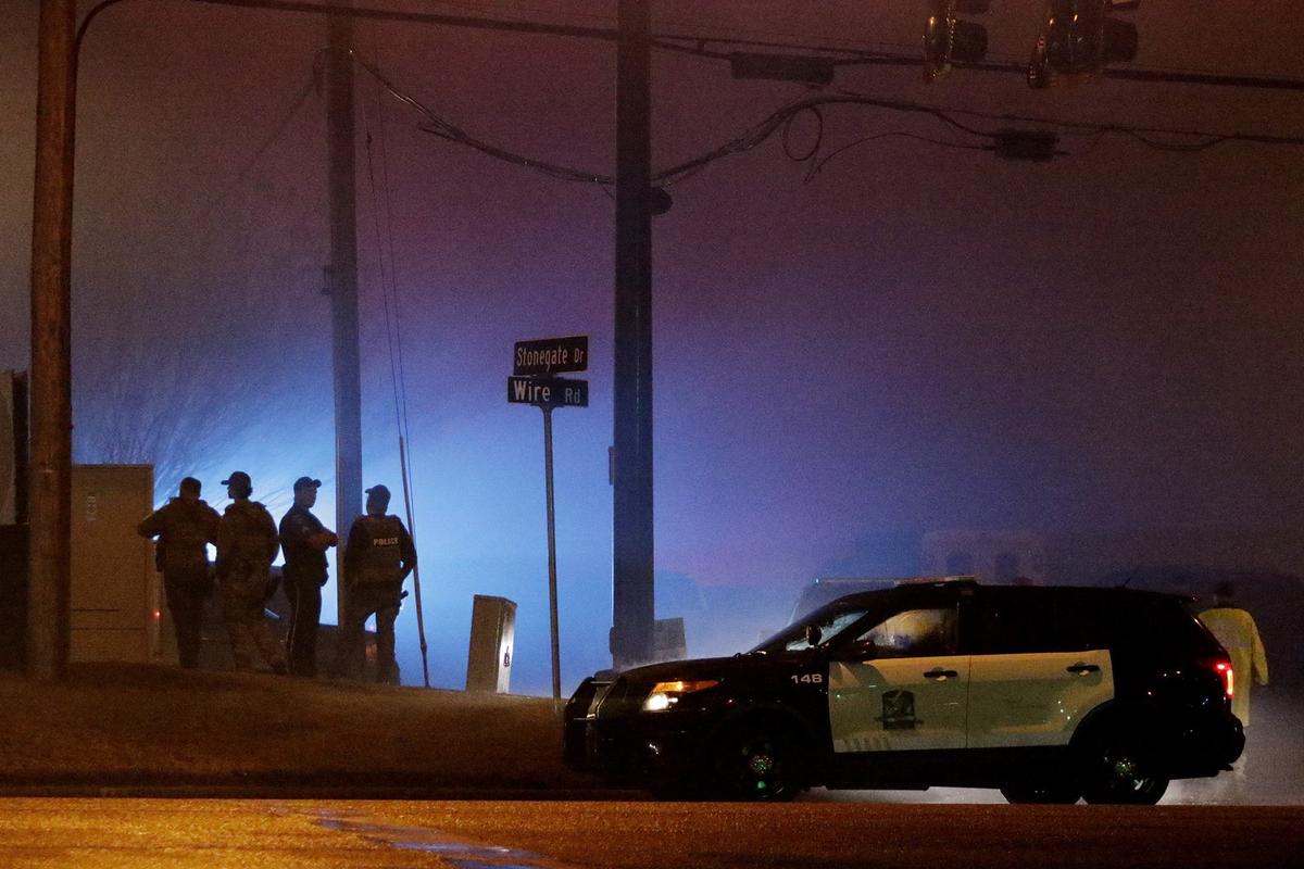 Law enforcement officers stand at the corner Stonegate Drive and Wire Road in Auburn, Ala.,on Feb. 15, 2019. (Emily Enfinger/Opelika-Auburn News via AP)