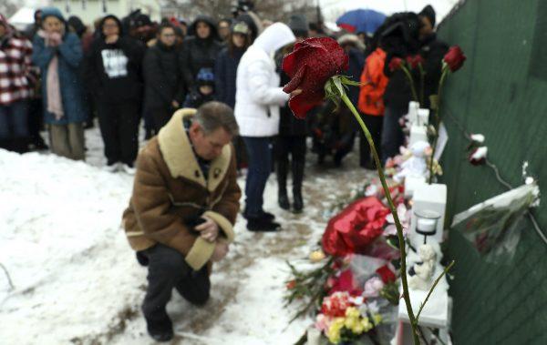 People pray at a makeshift memorial in Aurora, Ill., on Feb. 17, 2019. (Nam Y. Huh/AP)