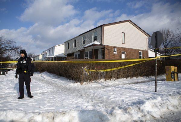 Police monitor the scene outside of a house where a young girl was found dead in Brampton, Ont. on Feb. 15, 2019. (The Canadian Press/Andrew Ryan)