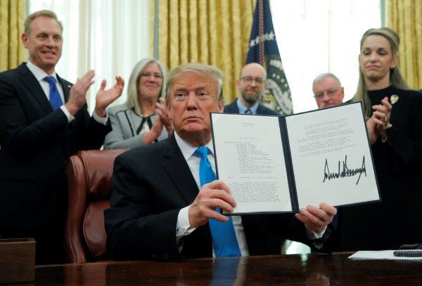 President Donald Trump displays the "Space Policy Directive 4" after signing the directive to establish a Space Force as the sixth branch of the Armed Forces in the Oval Office at the White House in Washington on Feb. 19, 2019. (Jim Young/Reuters)