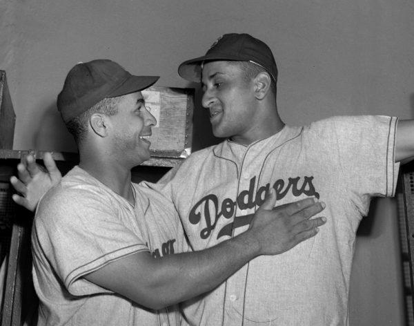 Brooklyn Dodgers Dodger catcher Roy Campanella, left, congratulates pitcher Don Newcombe after an 8-0 win against the New York Giants, at the Polo Grounds in N.Y., on Sept. 2, 1949. (Matty Zimmern/AP)