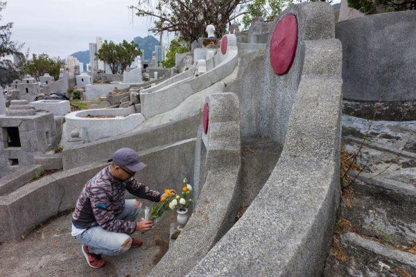 A man leaves offerings at the grave of a relative during the Chung Yeung Festival, or Tomb Sweeping Day, at a cemetery in Hong Kong on Oct. 17, 2018. (Anthony Wallace/AFP/Getty Images)