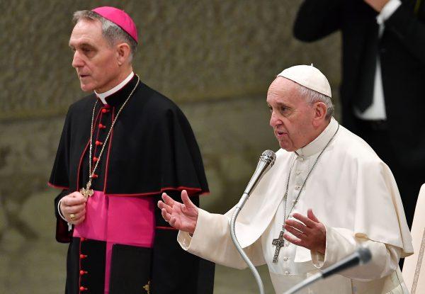 Pope Francis (R) flanked by Prefect of the papal household Georg Gaenswein, delivers his salute to worshipers at the start of the weekly general audience on Feb. 20, 2019 at Paul-VI hall in the Vatican. (VINCENZO PINTO/AFP/Getty Images)