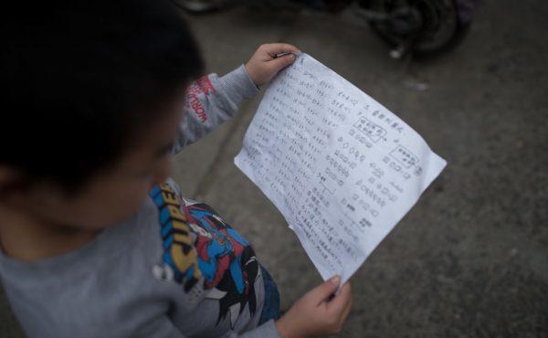 Chinese student looking at homework. (Johannes Eisele/AFP/Getty Images)