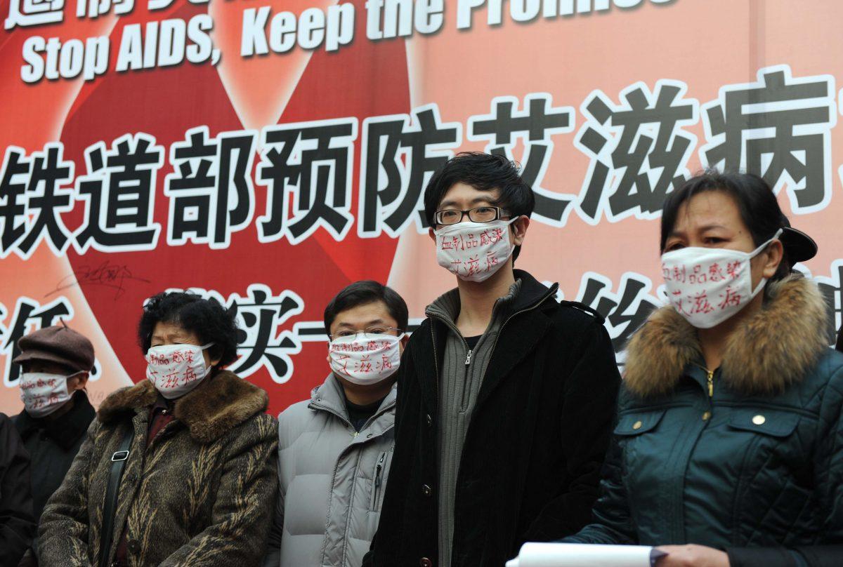 Hemophiliac protesters, all of whom contracted HIV from infected blood products, wear surgical masks as they demonstrate during an AIDS-awareness event on World AIDS Day at Beijing's south railway station on Dec. 1, 2009, to call for better government support for HIV/AIDS victims in China. (AFP/Getty Images)