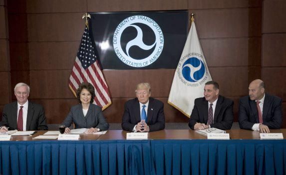 (L-R) Deputy Secretary of Transportation Jeffrey Rosen, Secretary of Transportation Elaine Chao, President Donald Trump, Acting Deputy Administrator of the Federal Highway Administration Walter Waidelich, and National Economic Council Director Gary Cohn wait for a roundtable discussion at the Department of Transportation in Washington on June 9, 2017. (Brendan Smialowski/AFP/Getty Images)
