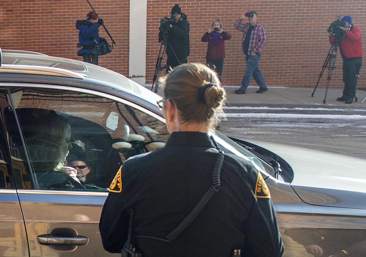 Krystal Jean Lee Kenney, left, leaves in a car as various media record her exit from the Teller Combined Court in Cripple Creek, Colo. on Feb. 8, 2019. (Dougal Brownlie/The Gazette via AP)