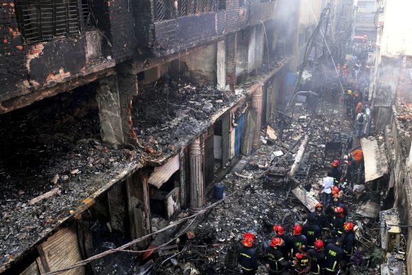 Locals and firefighters gather around buildings that caught fire late Wednesday in Dhaka, Bangladesh, on Feb. 21, 2019. (Rehman Asad/AP)