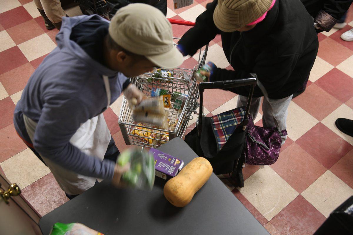Harlem residents pack free groceries at the Food Bank For New York City in New York City on Dec. 11, 2013. (John Moore/Getty Images)