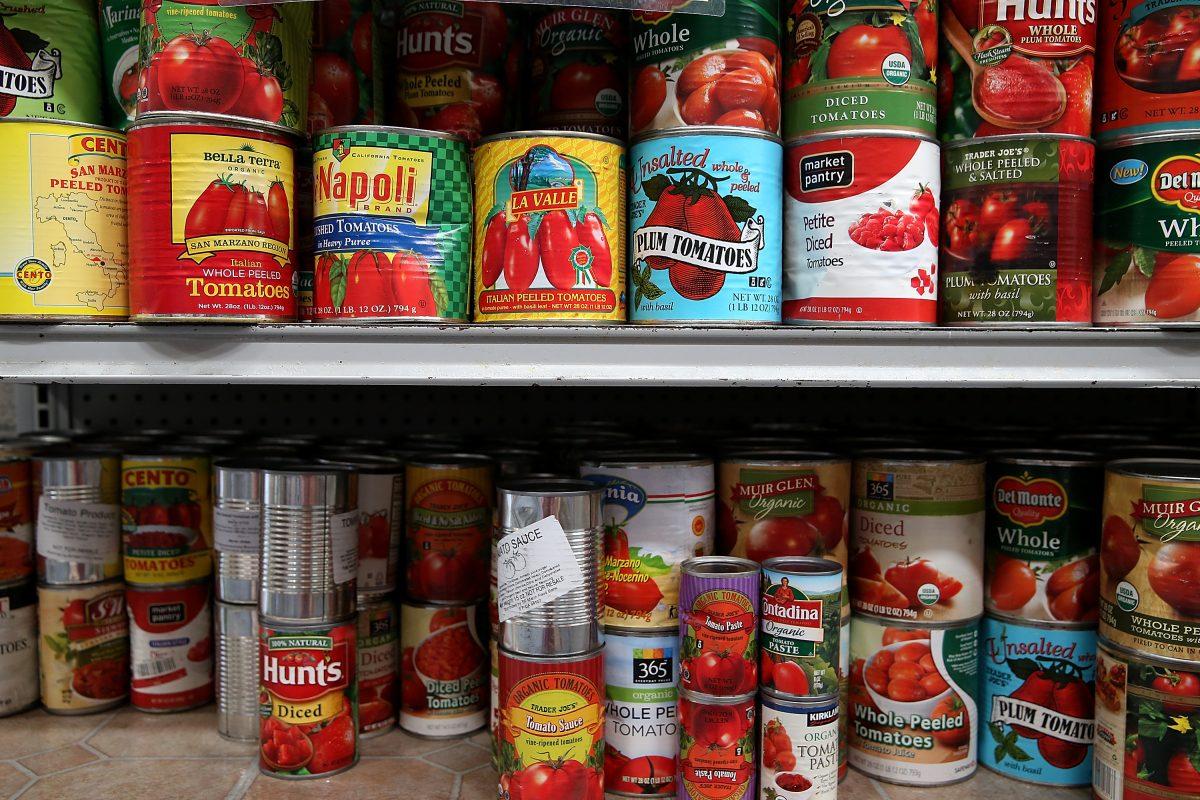 Canned tomatoes line the shelves of a pantry at the SF-Marin Food Bank in San Francisco, California on May 1, 2014. (Justin Sullivan/Getty Images)