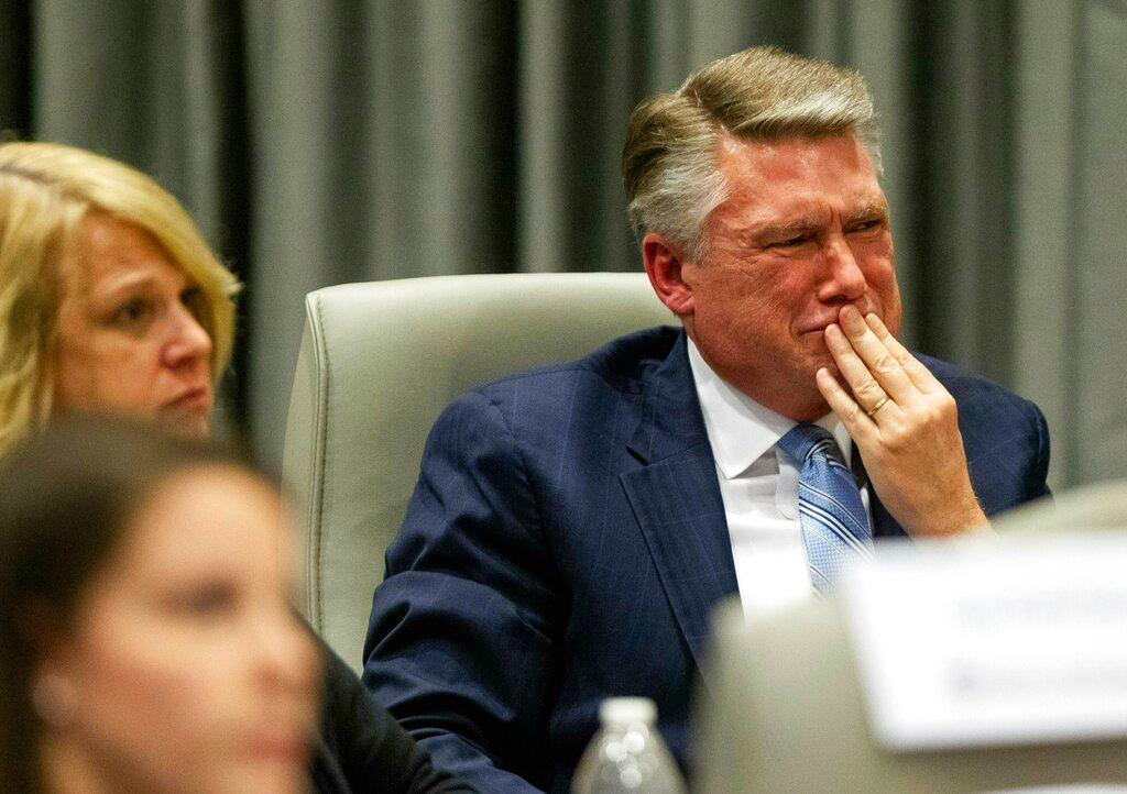 Mark Harris, Republican candidate in North Carolina's 9th Congressional race, fights back tears at the conclusion of his son John Harris's testimony during the third day of a public evidentiary hearing on the 9th Congressional District voting irregularities investigation Wednesday, Feb. 20, 2019, at the North Carolina State Bar in Raleigh. (Travis Long//The News & Observer/AP/Pool)
