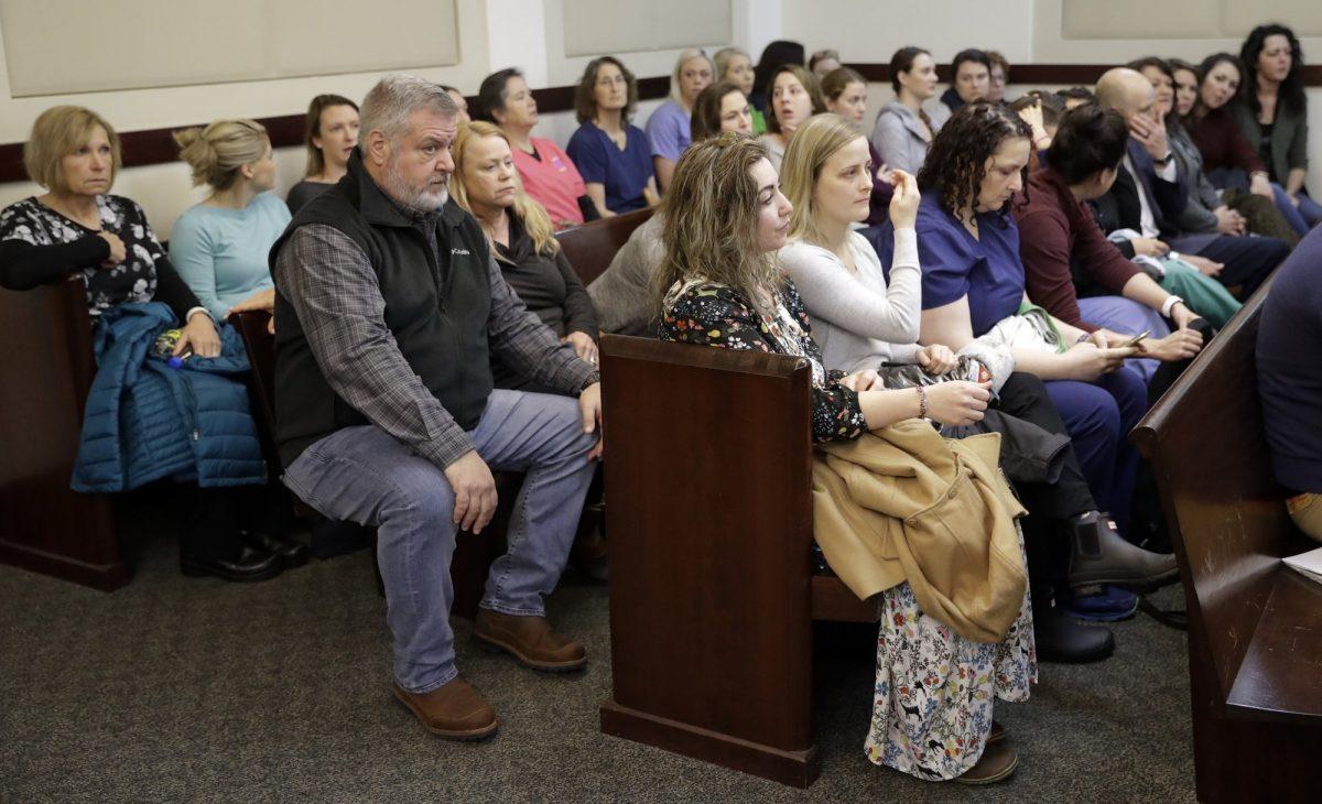RaDonda Vaught, front right, sits with supporters as she waits for her court hearing in Nashville, Tenn. Vaught on Feb. 20, 2019 (Mark Humphrey/AP Photo)