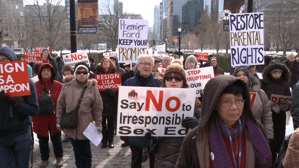 Protestors outside Queens Park demand Minister of Education Lisa Thompson step down, saying she failed to repeal the Wynne government's sex-ed curriculum, in Toronto, Canada on Feb. 20, 2019. (NTD Television)