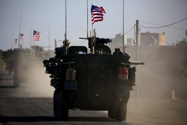 A convoy of US forces armored vehicles drives near the village of Yalanli, on the western outskirts of the northern Syrian city of Manbij, on March 5, 2017. (Delil Souleiman/AFP/Getty Images)