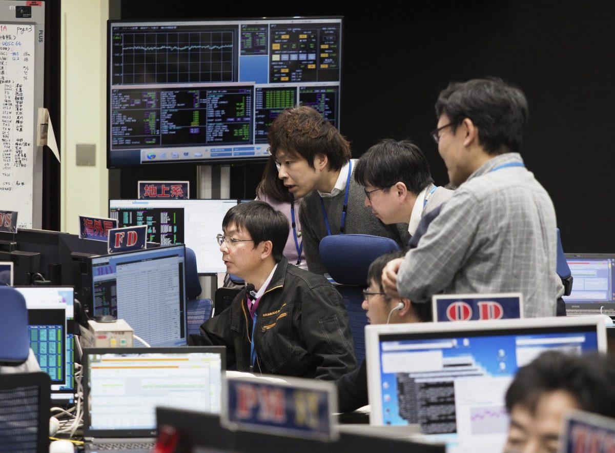 Staff of the Hayabusa2 Project watch monitors for a safety check at the control room of the JAXA Institute of Space and Astronautical Science in Sagamihara, near Tokyo, on Feb. 21, 2019. (ISAS/JAXA via AP)