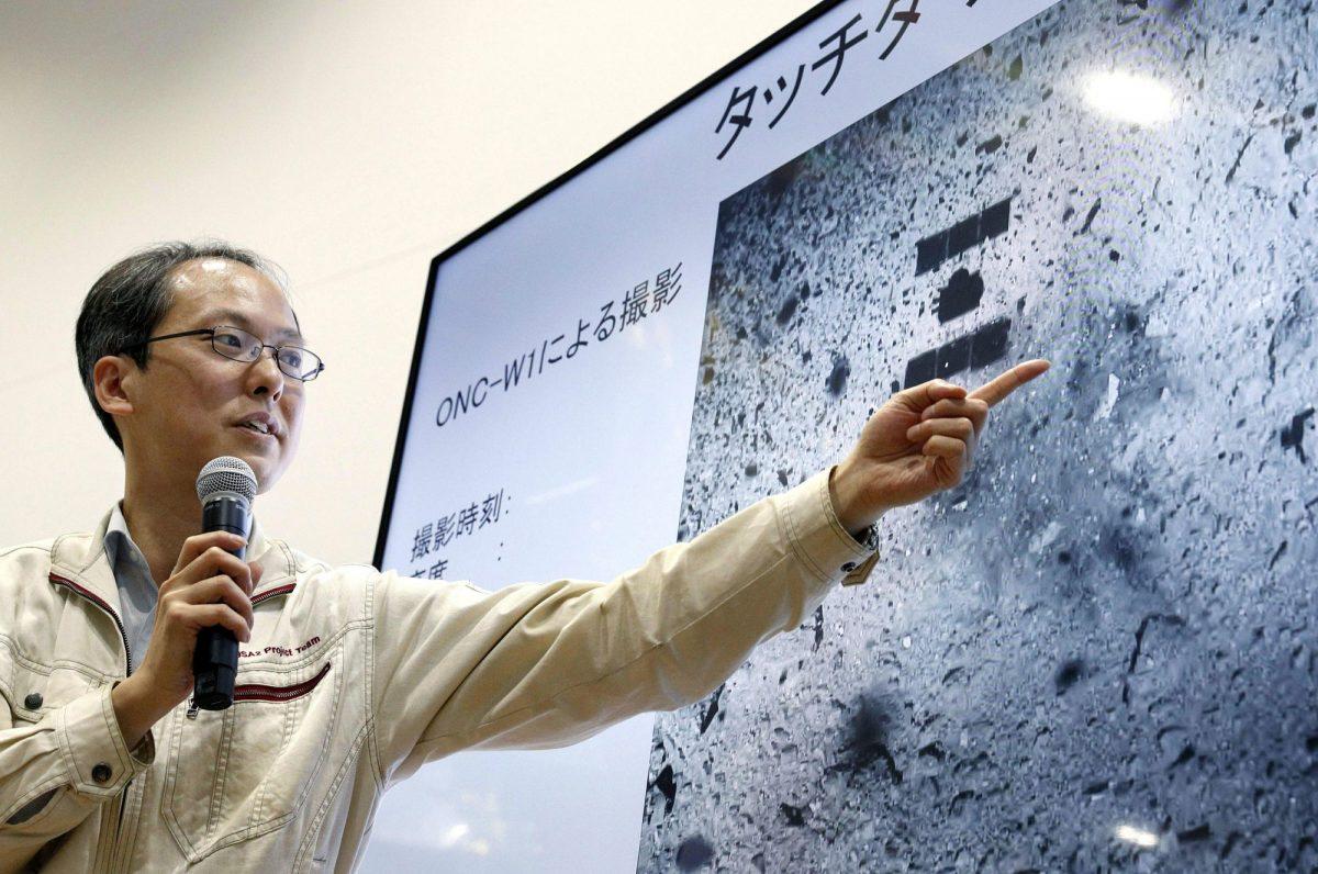 Associate Prof. Yuichi Tsuda of the Japan Aerospace Exploration Agency (JAXA) using an image of the surface of the asteroid Ryugu speaks about the touchdown by the Hayabusa2 spacecraft during a press conference in Sagamihara, near Tokyo, on Feb. 22, 2019.  (Kyodo News via AP)