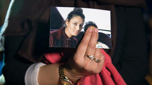 Renu Begum, eldest sister of Shamima Begum, 15, holds her sister's photo as she is interviewed by the media at New Scotland Yard, in London, on Feb. 22, 2015. (Laura Lean/WPA Pool/Getty Images)