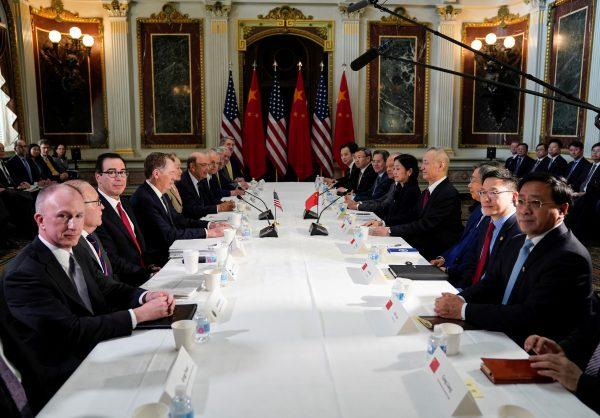 U.S. Trade Representative Robert Lighthizer (4thL), Treasury Secretary Steven Mnuchin (3rdL), Commerce Secretary Wilbur Ross, White House economic adviser Larry Kudlow and White House trade adviser Peter Navarro pose for a photograph with China's Vice Premier Liu He (4thR), Chinese vice ministers and senior officials before the start of US-China trade talks at the White House in Washington on Feb. 21, 2019. (Joshua Roberts/Reuters)