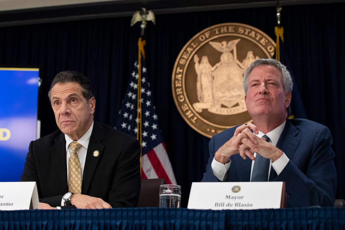 New York Gov. Andrew Cuomo (L) and New York City Mayor Bill de Blasio listen to questions from reporters during a press conference in New York City to discuss Amazon's decision to bring a new corporate location to the city, on Nov. 13, 2018. (Drew Angerer/Getty Images)