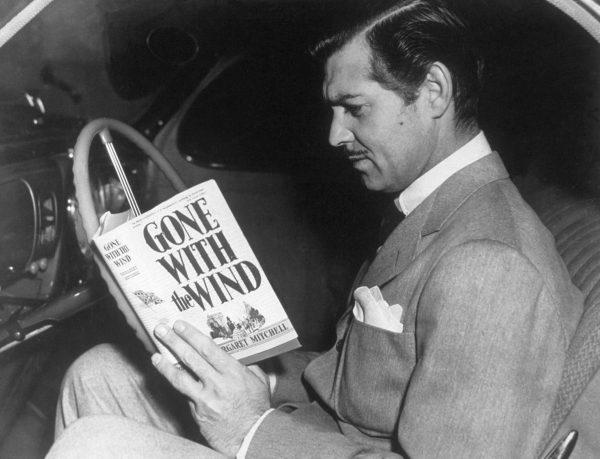 American film star Clark Gable (1901-1960) reading the novel "Gone With the Wind" by Margaret Mitchell. His greatest role was that of Rhett Butler in the MGM film adaption of the book. (Hulton Archive/Getty Images)
