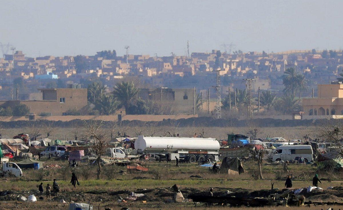 Islamic state members walk in the last besieged neighborhood in the village of Baghouz, Deir Al Zor province, Syria on Feb.18, 2019. (Rodi Said/REUTERS/File Photo)